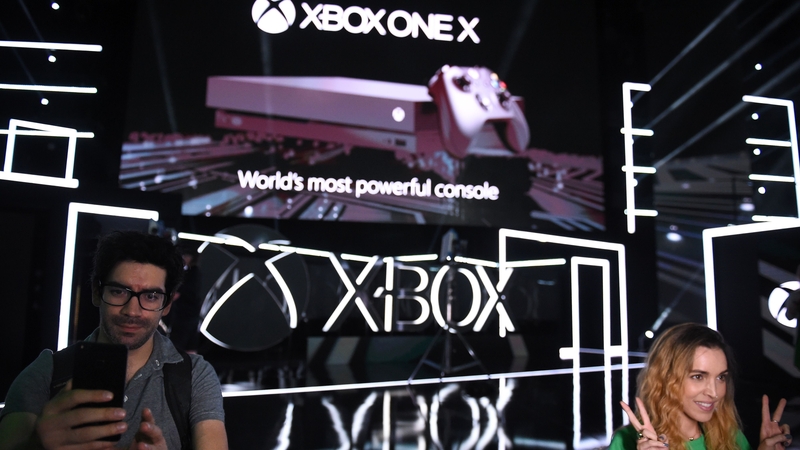 Fans take their photo in front of an image of the new Xbox at E3