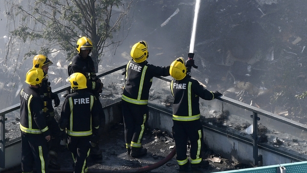 May promises 'proper' inquiry after London tower fire