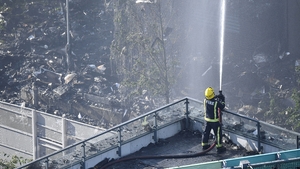 A fire fighter tackles the blaze at the scene
