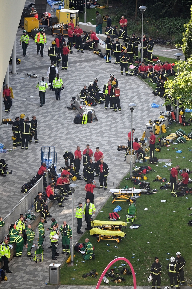 Emergency services gather outside the tower block during the operation to bring the blaze under control