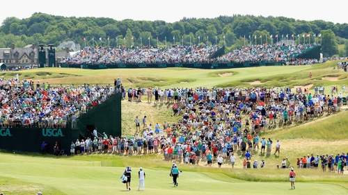 Spectators flock around the action at Erin Hills