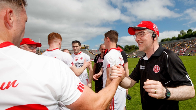 Mickey Harte celebrates with Darren McCurry at the final whistle