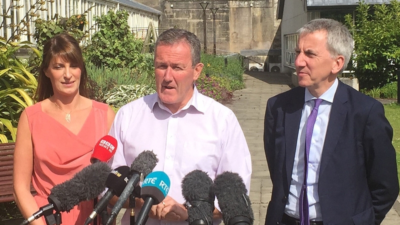 Conor Murphy (centre) speaking after talks