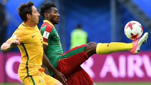 Mark Milligan (L) and Andre Zambo battle for possession