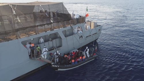Rescued migrants are pictured being brought aboard the Irish Navy vessel