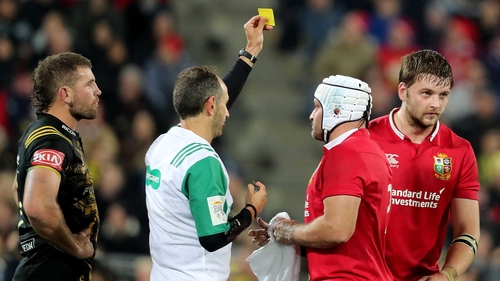 Referee Romain Poite shows Henderson a yellow card