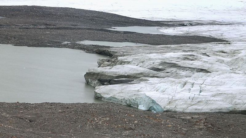 Recently uncovered earth is seen near one of Greenland's retreating glaciers