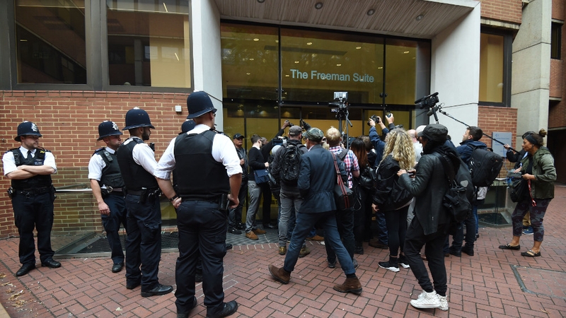 People gather outside Kensington Town Hall after the meeting was adjourned