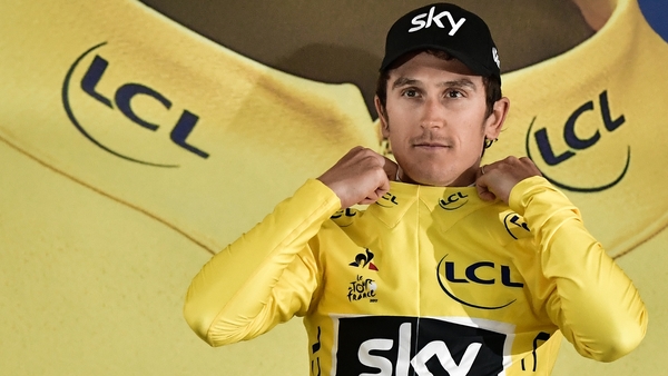 Geraint Thomas pulls on the first yellow jersey of the 2017 Tour