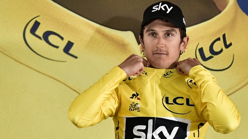 Geraint Thomas pulls on the first yellow jersey of the 2017 Tour