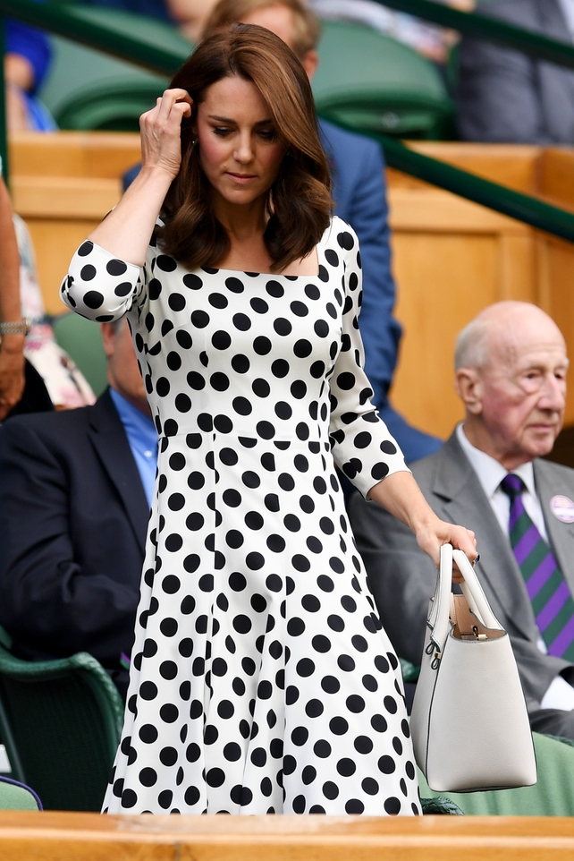 The Duchess of Cambridge looks on from centre court wearing a Dolce and Gabbana polka dot dress.