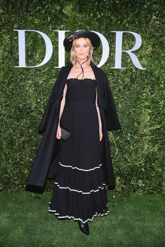 supermodel Eva Herzigova is giving us some Zoro vibes with this ruffled skirt, coboy hat and cape.