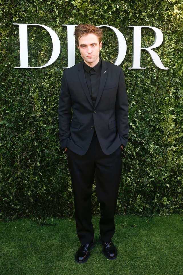 Actor Robert Pattinson looks chic in all black at the Dior photocall.