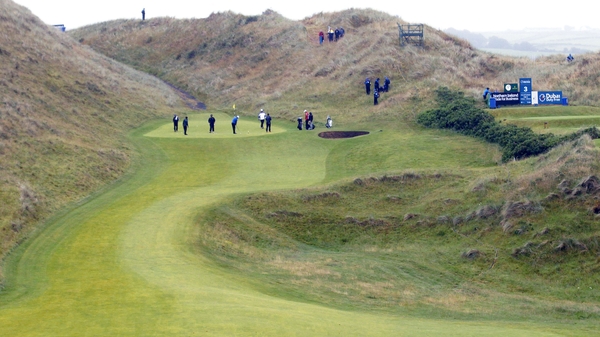 Golfers make their way along the second fairway