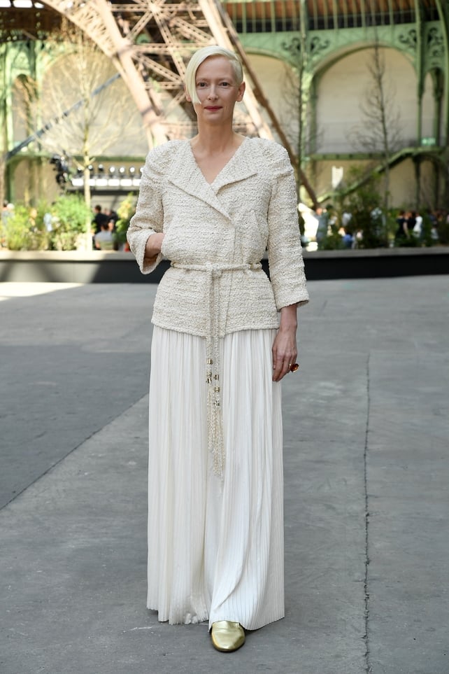 July 4: A vision in white at the Chanel Haute Couture Fashion Show! Actress Tilda Swinton matched her bleached hair with this white ensemble paired with gold shoes.