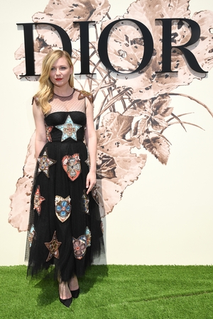 July 3: Actress Kirsten Dunst is gorgeous in this embroidered tulle dress at the Dior Fashion Show.