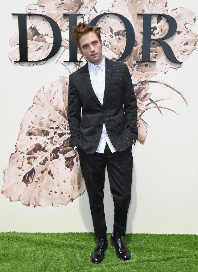 July 3: Dior muse and actor Robert Pattinson is effortlessly chic in this striped suit and shirt combo with boots at the Dior Fashion Show.
