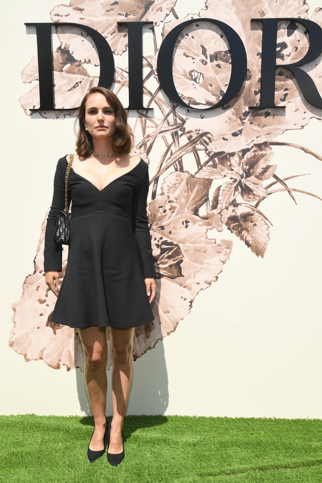 July 3: Another Dior muse, Natalie Portman is giving us Hollywood vibes in this plunging neckline mini dress, cat eye make up and wavy hair at the Dior Fashion Show. Classic.