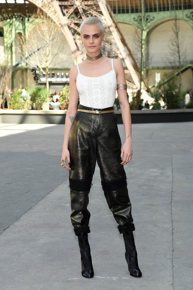 July 4: Model Cara Delevingne rocking her new bold haircut in sparkling pants and gold accessories. The Chanel choker is a must for the Chanel Haute Couture Fashion Show.