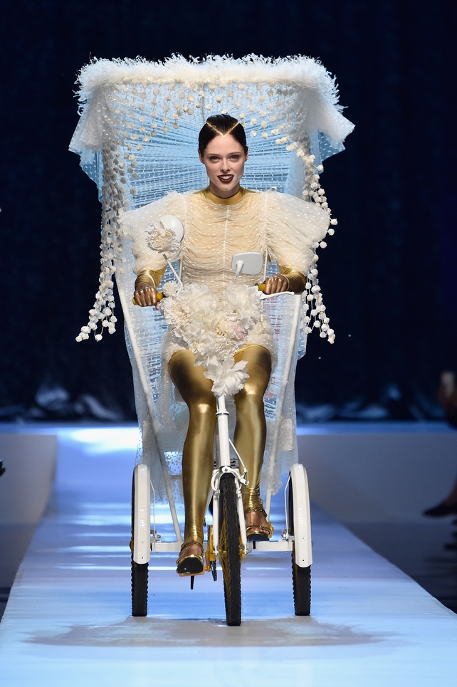 July 5: The astonishingly beauty Coco Rocha riding on the Jean Paul Gaultier catwalk in gold pants and sheer dress. Gaultier is so creative!