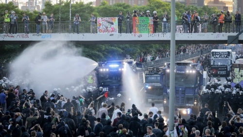 Police water cannons in operation during the protest in Hamburg