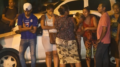 Families wait for news after the riot left 28 dead and three injured