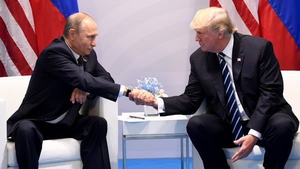 Vladimir Putin and Donald Trump shake hands