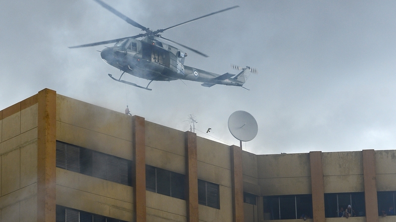 The government sent in helicopters to rescue people in the ministry as video showed thick plumes of smoke streaming from the building