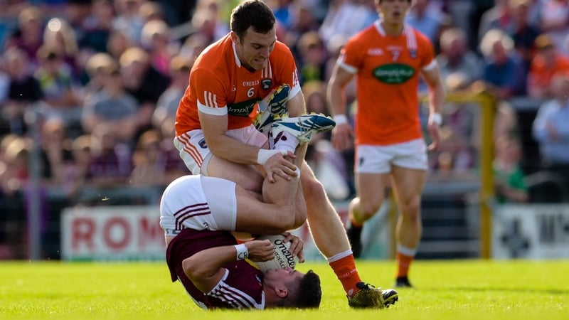 WestmeathÕs John Egan is fouled by Brendan Donaghy of Armagh