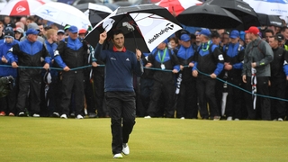 Jon Rahm takes in the atmosphere as he strolls up the final hole at Portstewart