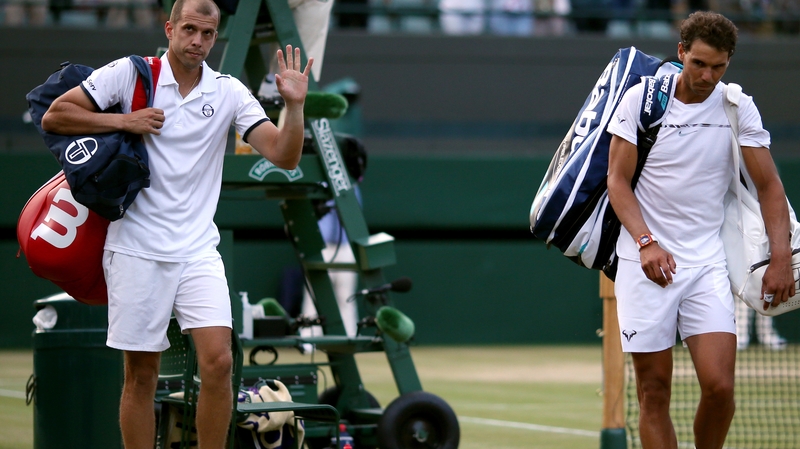 Rafael Nadal after losing to Gilles Muller (r)