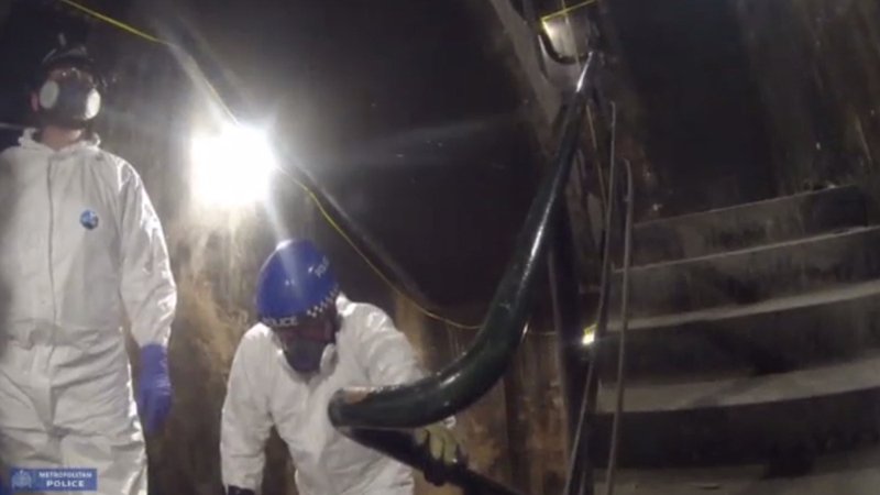 Officers are seen catching their breath as they climbed the staircase