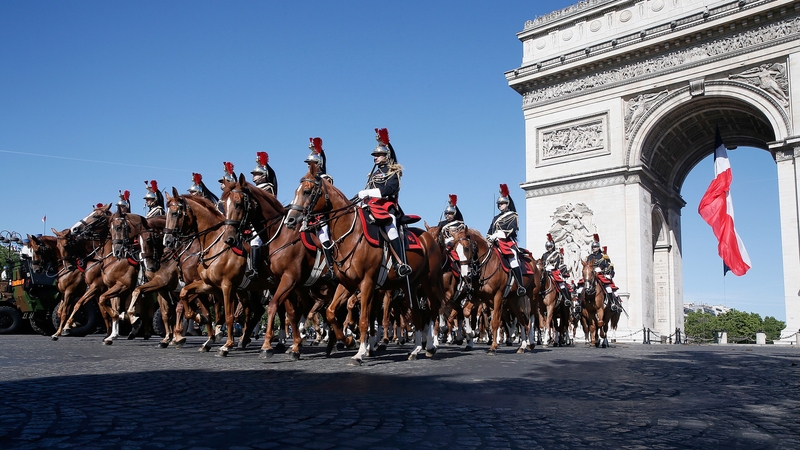 French Mounted Republican guards ride past the Arc de Triomphe