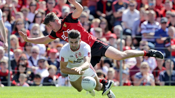 Peter Turley collides with Tyrone's Tiernan McCann