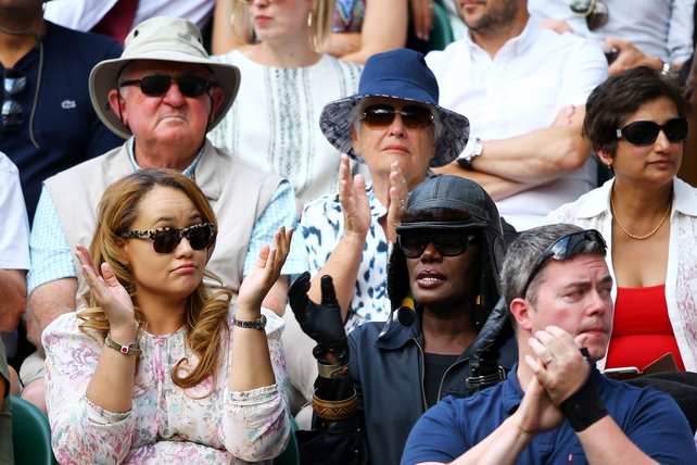 Grace Jones watches the action on centre court wearing some Winter accessories.