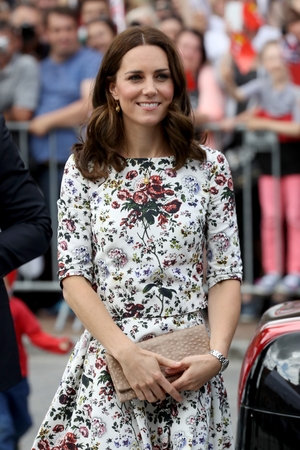 The Duchess accessorised her look with a clutch bag from Poland's Etui Bags and a Cartier watch.