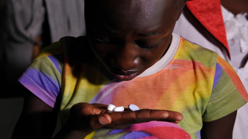 A young Kenyan girl takes her antiretroviral drugs - African countries have made great progress in fight against AIDS
