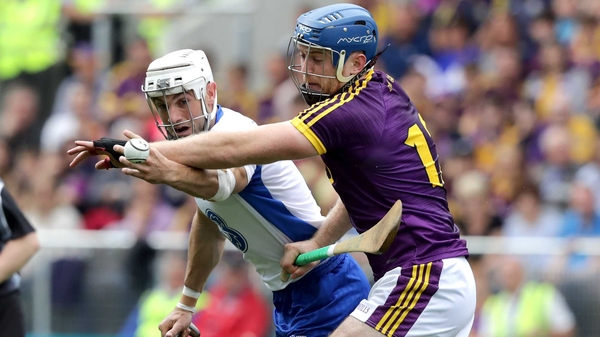 Shane Fives and Jack Guiney battle for possession