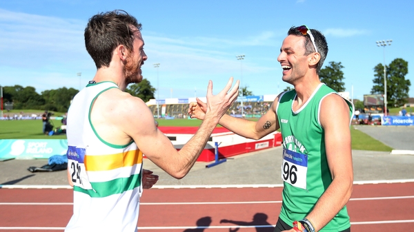 Paul Byrne congratulates his training partner Tom Barr after their 400m hurdle race