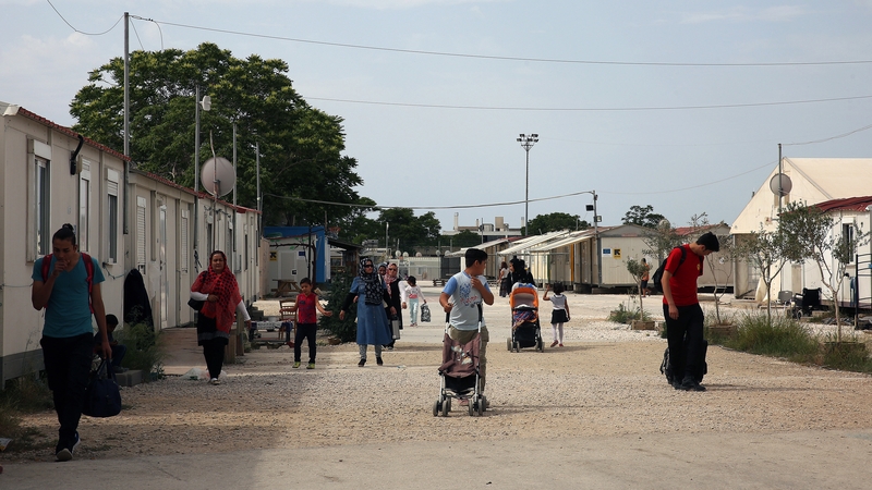 People are seen in a refugee camp in Greece