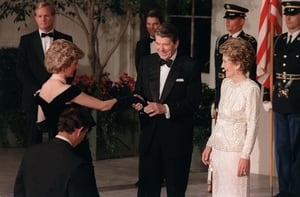 Ronald Reagan and his wife Nancy welcome Princess Diana to the White House in 1985. Diana wore a midnight blue Victor Edelstein gown.