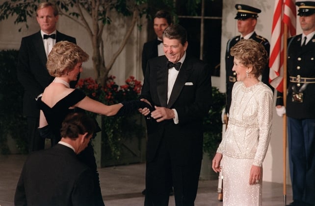 Ronald Reagan and his wife Nancy welcome Princess Diana to the White House in 1985. Diana wore a midnight blue Victor Edelstein gown.