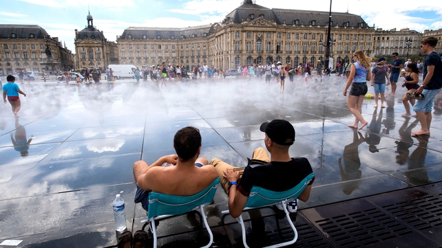 People refresh themselves in the Water Mirror fountain in the center of Bordeaux, France, yesterday