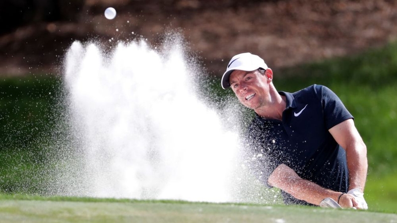 Rory McIlroy plays his shot on the 12th hole during the first round