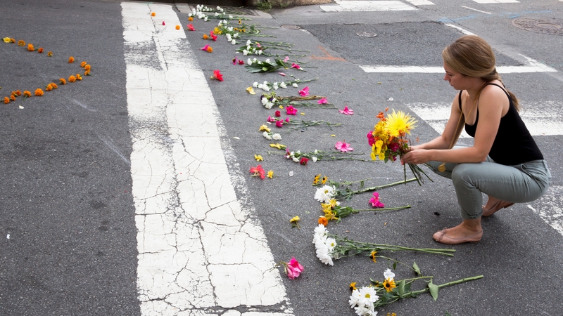 A woman places flowers at the site of the fatal crash in Virginia