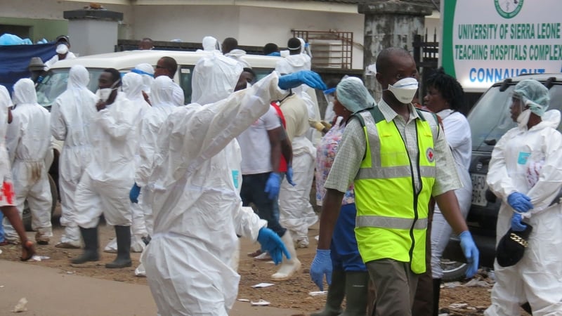 Members of the burial team gather to collect bodies