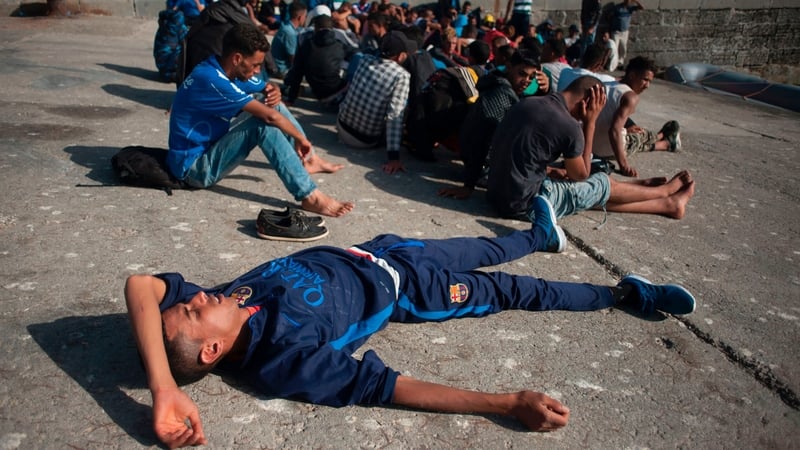 A group rests after being rescued in the waters of the Strait of Gibraltar