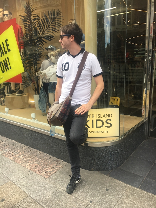 Darren Hughes wears a t-shirt from refugee charity Karátepé for which he hosted a fundraiser recently. His sunglasses are Polaroids from Boots and his trousers are Lee jeans. He bought his bag in Billabong.