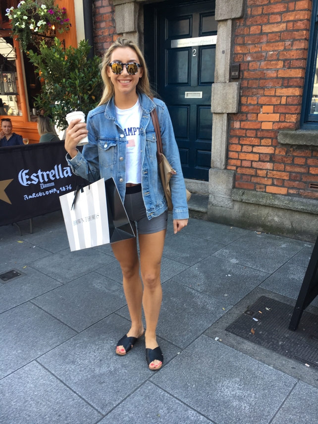 Kelsey Latham wears a denim jacket from H&M over a t-shirt from Topshop and shorts by Nike. Her shoes are from Aldo and her glasses are by Krewe Du Optics.