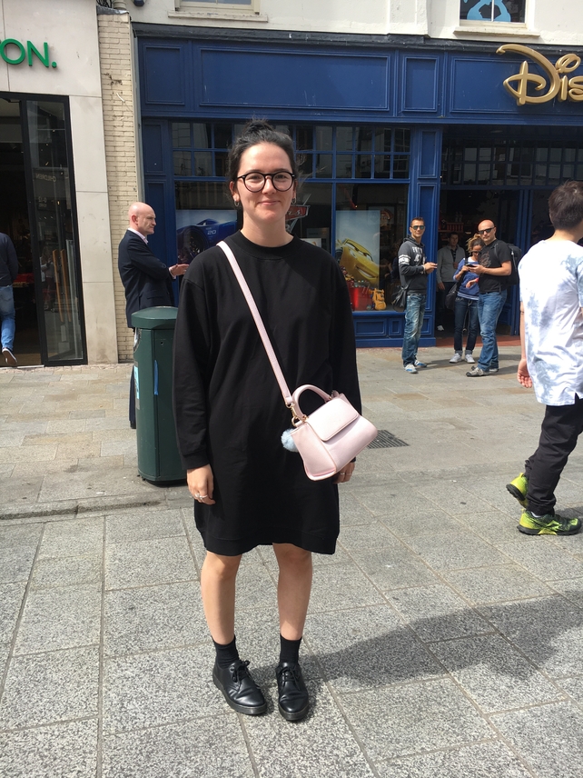 Lucy Mortell wears a black shift dress from Asos.com, boots by Dr. Martens and finishes the look with a bag from Skinny Dip.
